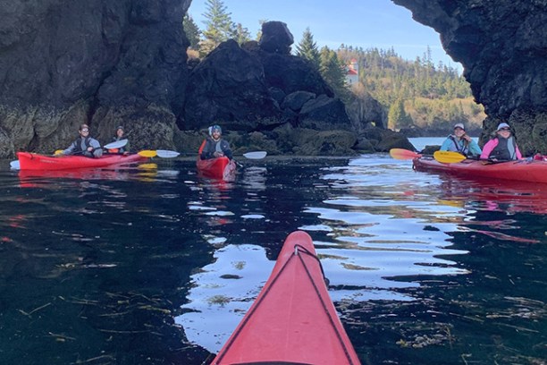 a group of people in a small boat in a body of water